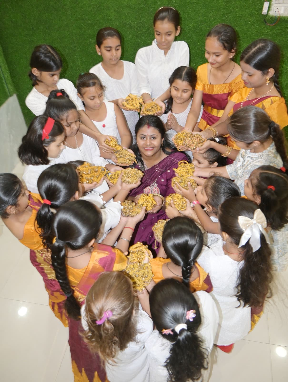 Students gathered in a circle around their seated teacher