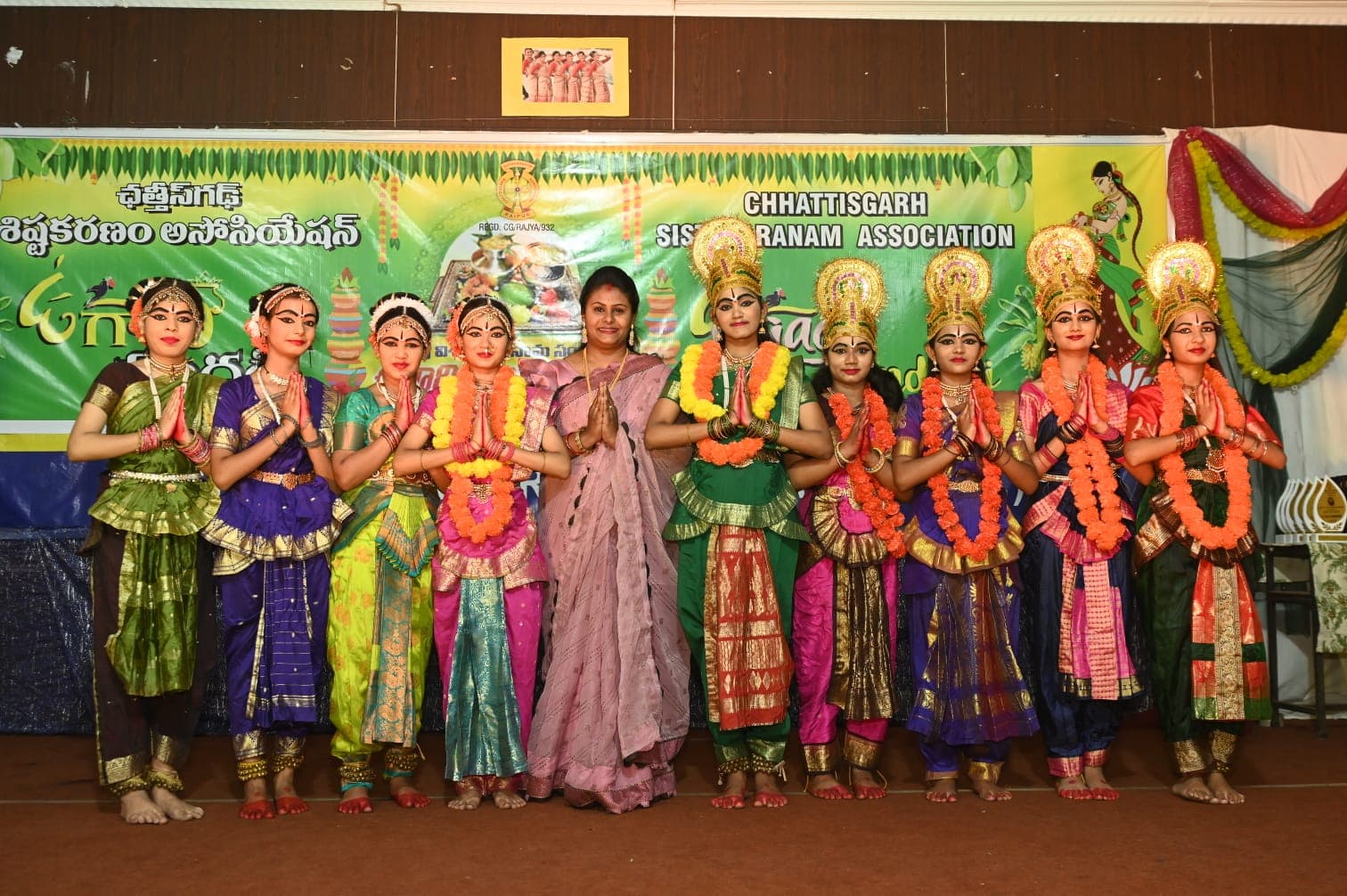 Young classical dancers posing in a line on a decorated stage