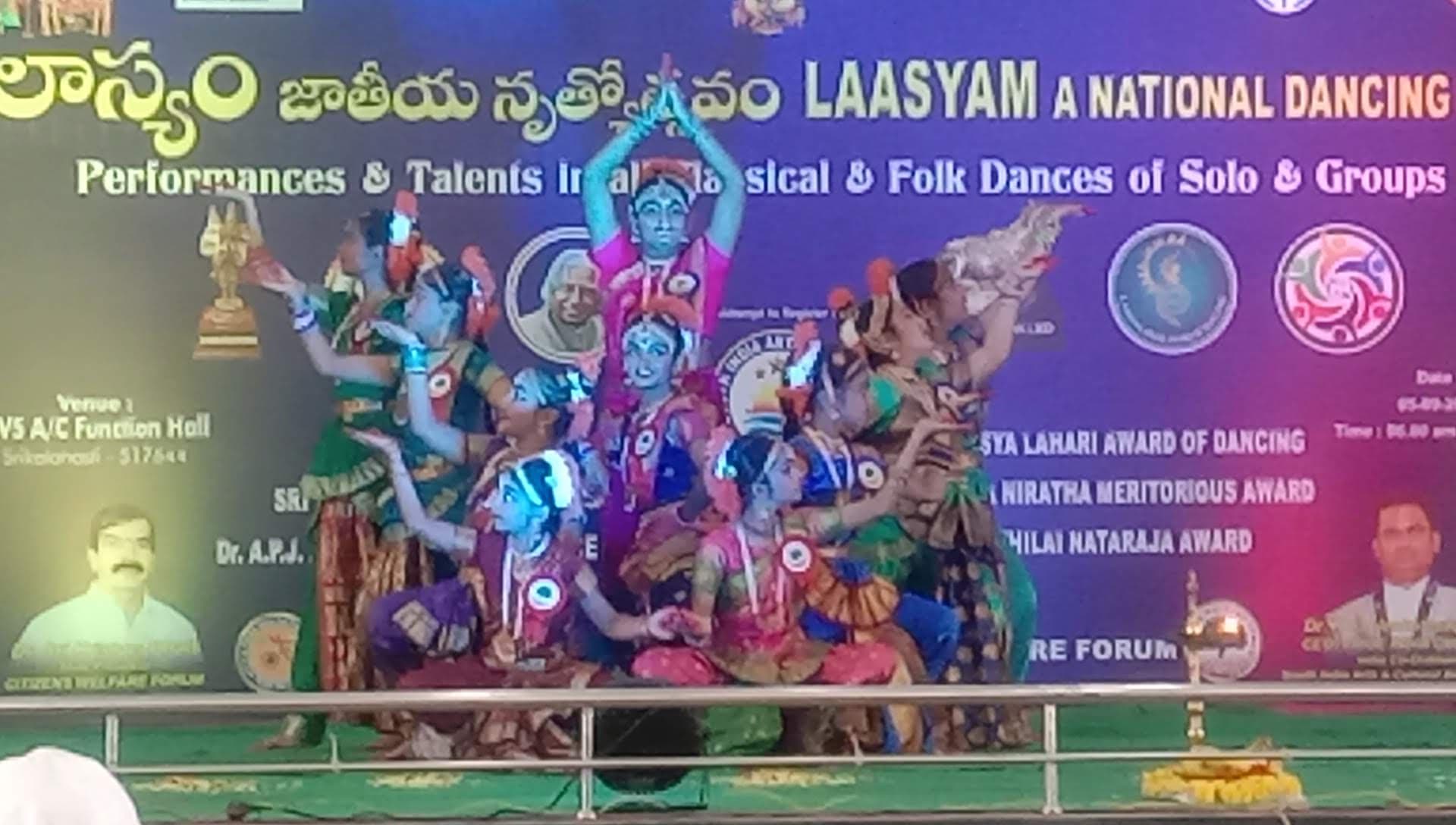 A classical dance group performing a multi-level formation at Laasyam