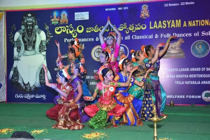 Classical dancers forming a layered tableau on the Laasyam stage