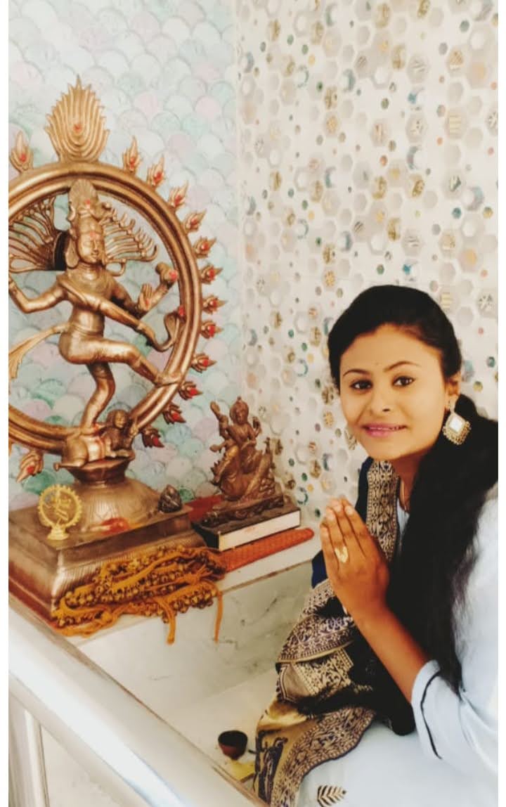 A portrait beside a bronze Nataraja sculpture