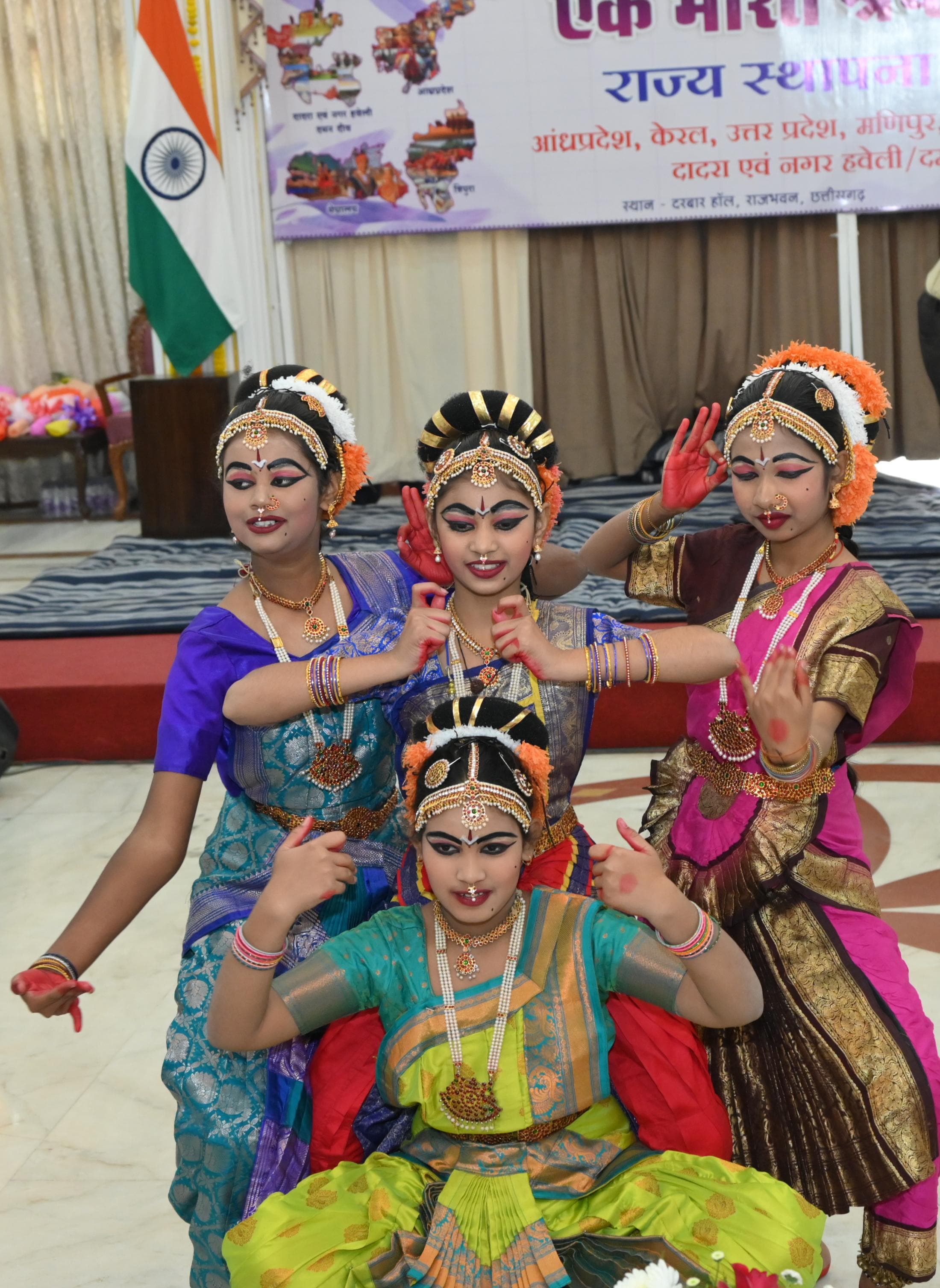 Four young dancers posing in colourful classical costumes