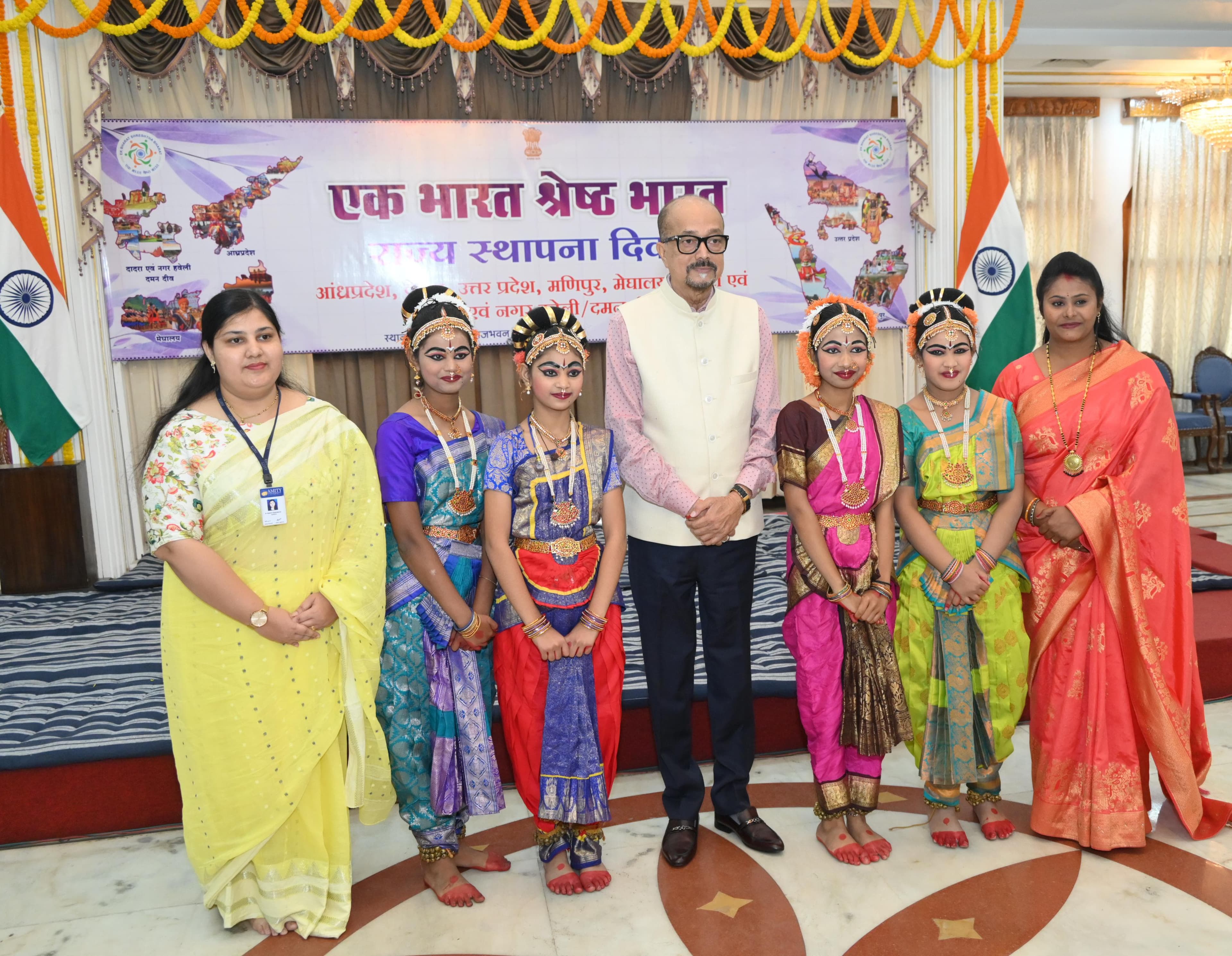 Dancers and guests posing beneath an Ek Bharat Shreshtha Bharat banner