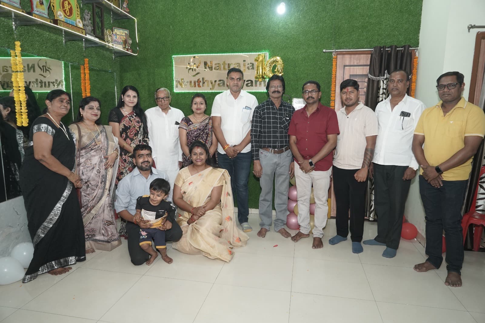 Adults gathered for a photograph inside the academy studio