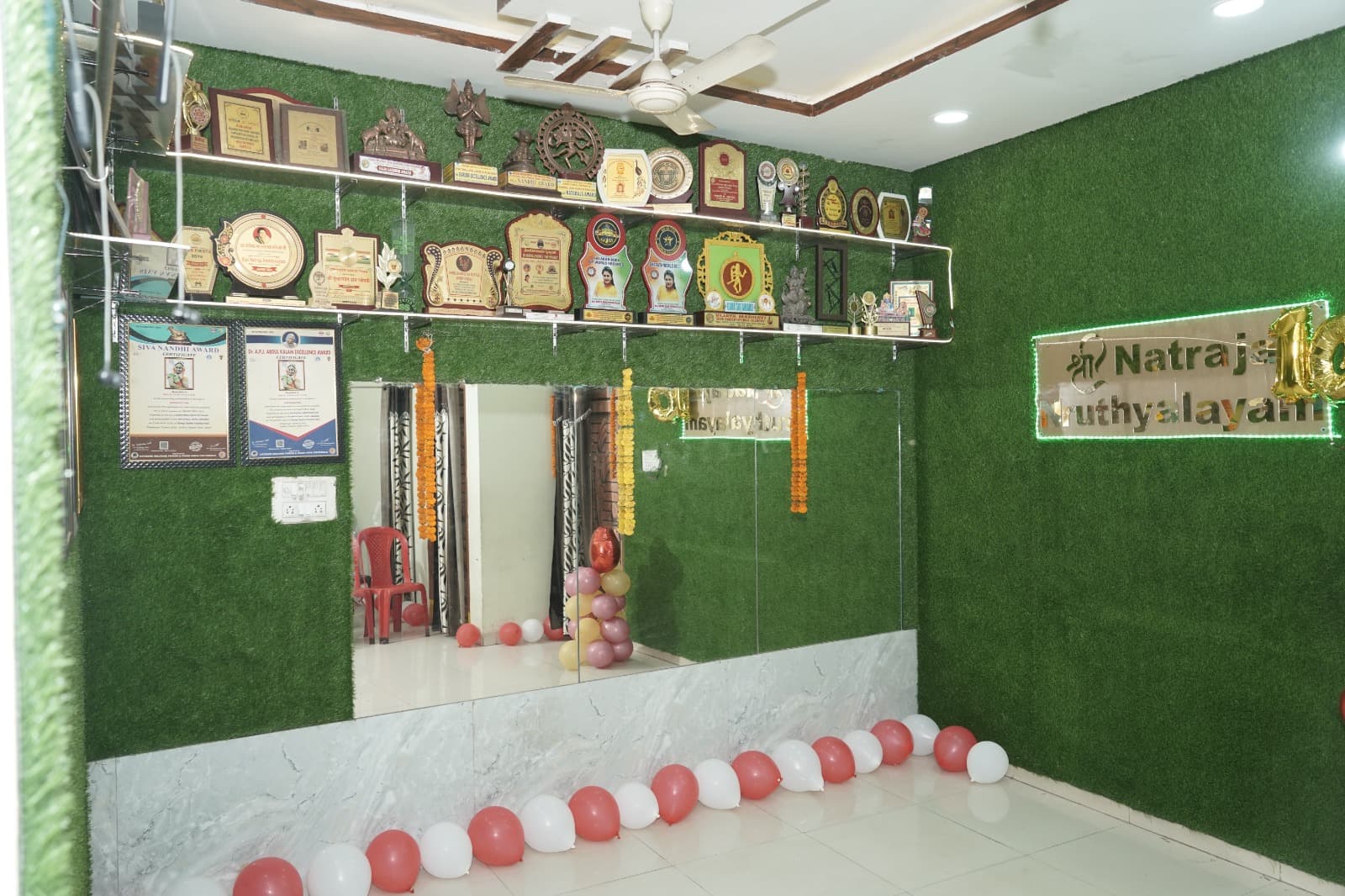 The academy studio with trophies, certificates and a wall mirror