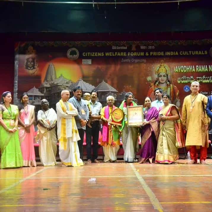 Artists and guests on stage during a ceremonial presentation
