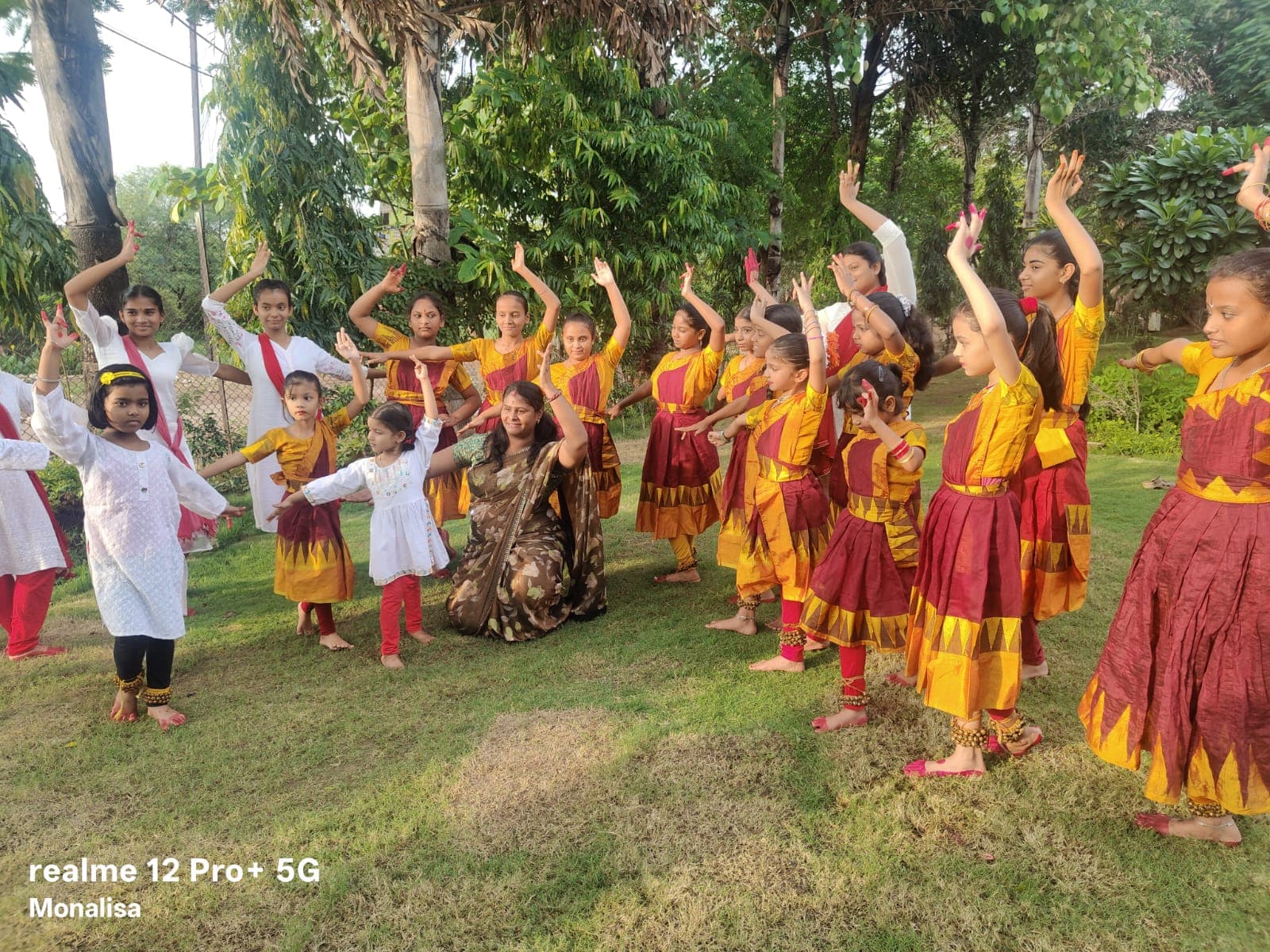 Dance students practising expressive poses together outdoors